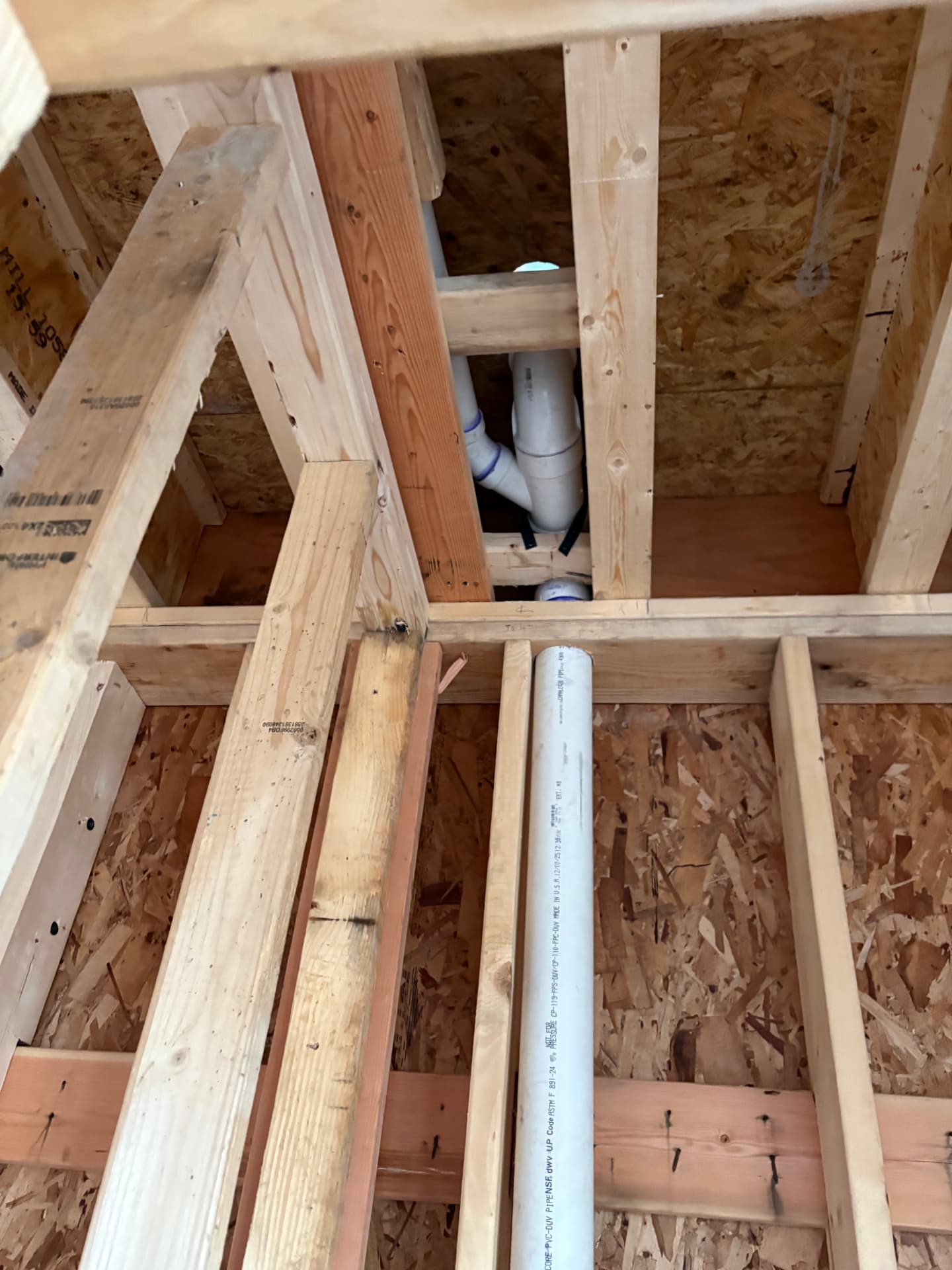 PVC vent stacks and drainage lines in a framed room during rough-in in Hanover, MD — ProStream Plumbing
