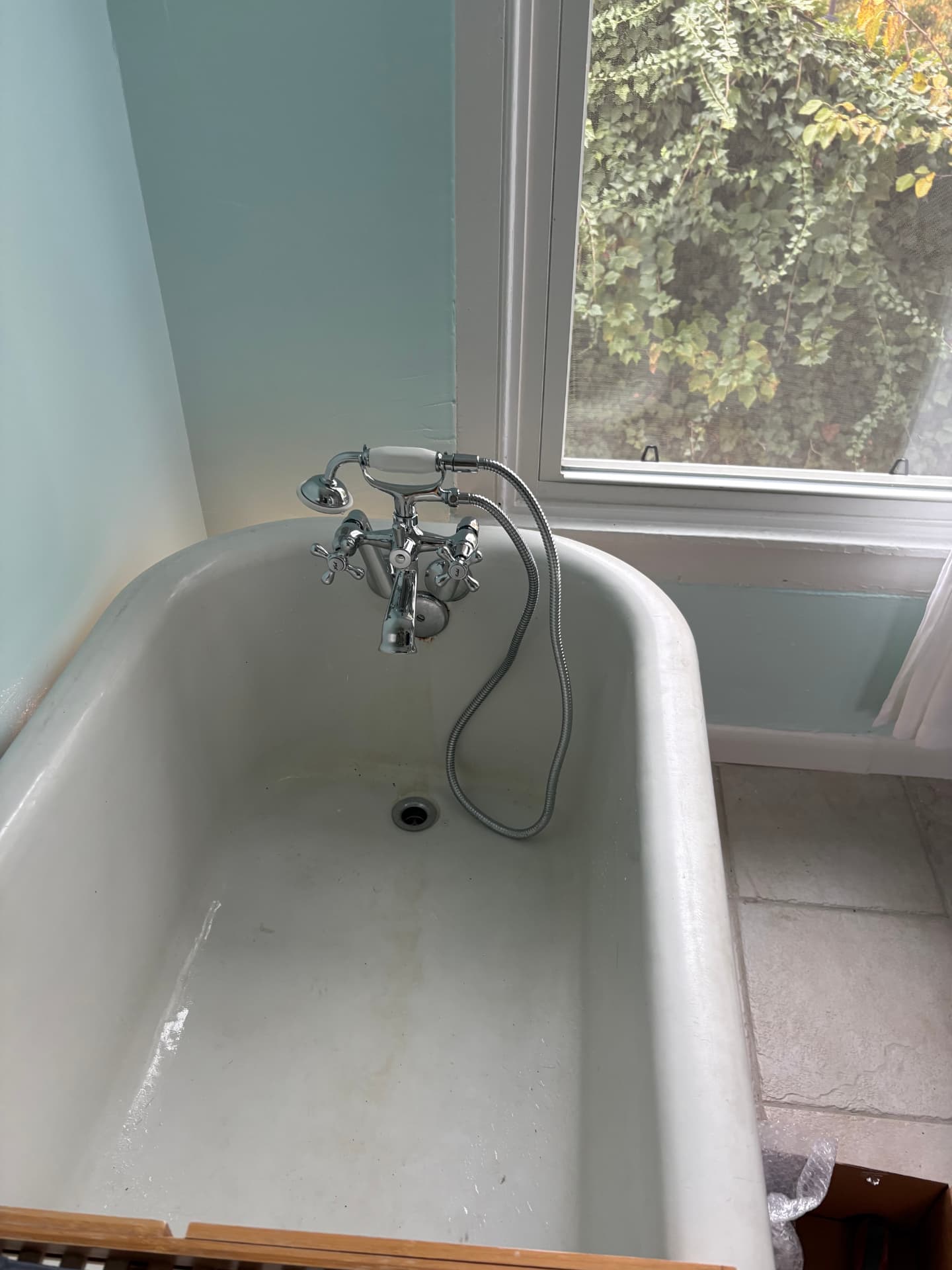 New chrome clawfoot tub filler with vintage-style hand shower installed in Baltimore, MD — ProStream Plumbing