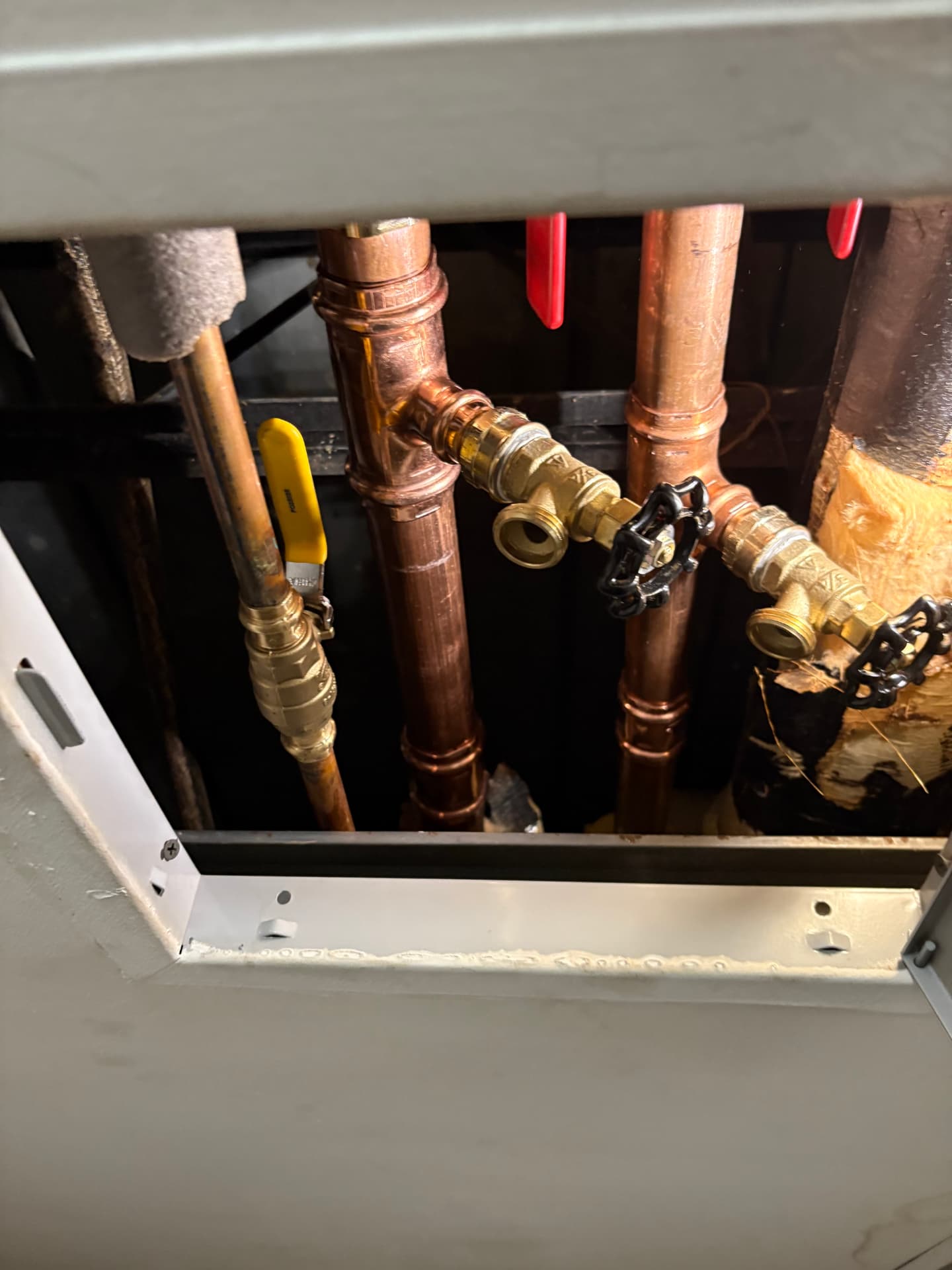 New copper water lines with brass ball valves behind a ceiling access panel in Baltimore, MD — ProStream Plumbing