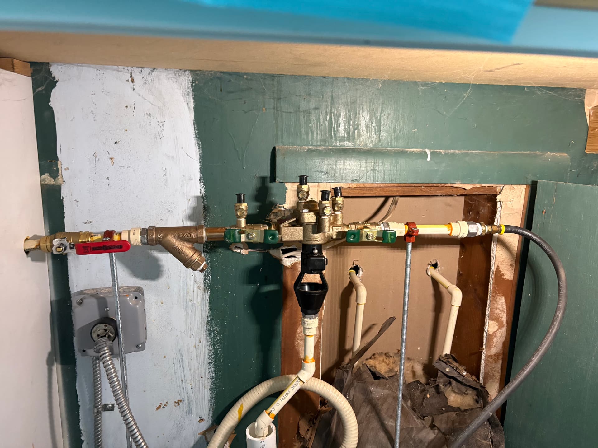 Brass backflow preventer and valve assembly with Y-strainer mounted on a wall in Baltimore, MD — ProStream Plumbing