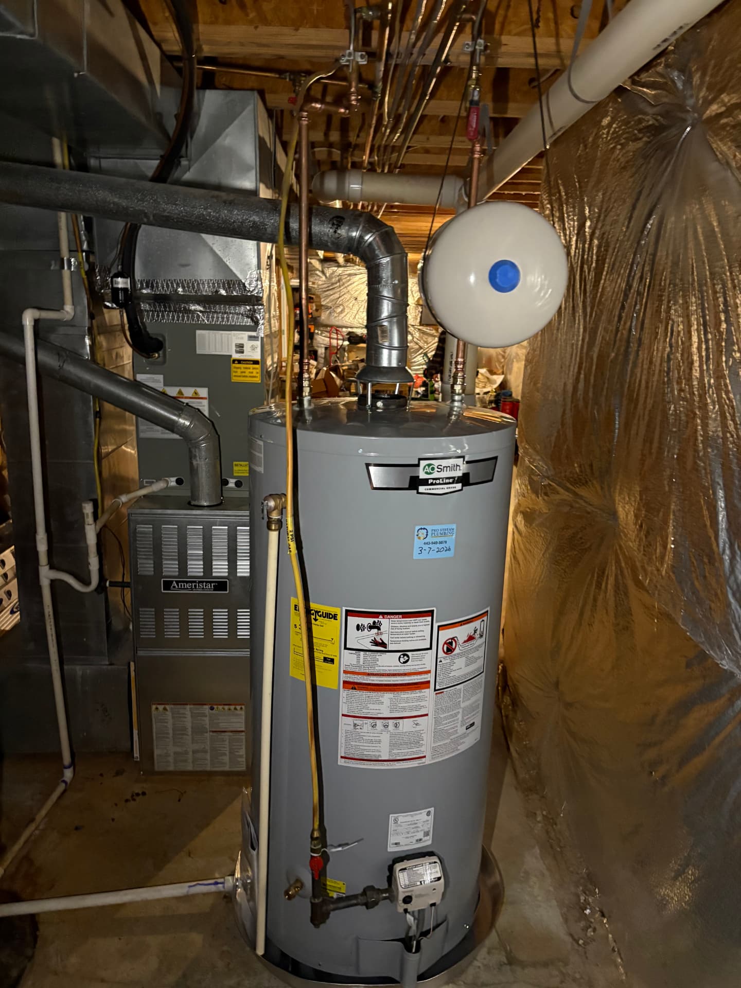 New A.O. Smith gas water heater with expansion tank and ProStream service sticker in Baltimore, MD — ProStream Plumbing