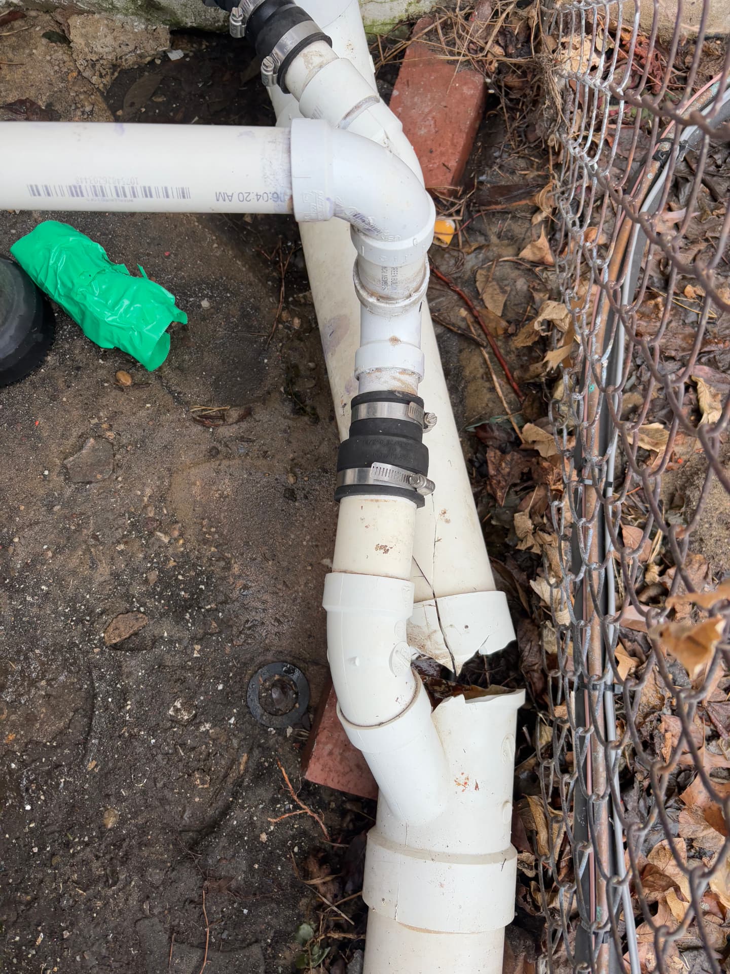Cracked exterior PVC drain pipe junction before repair in Arbutus, MD — ProStream Plumbing