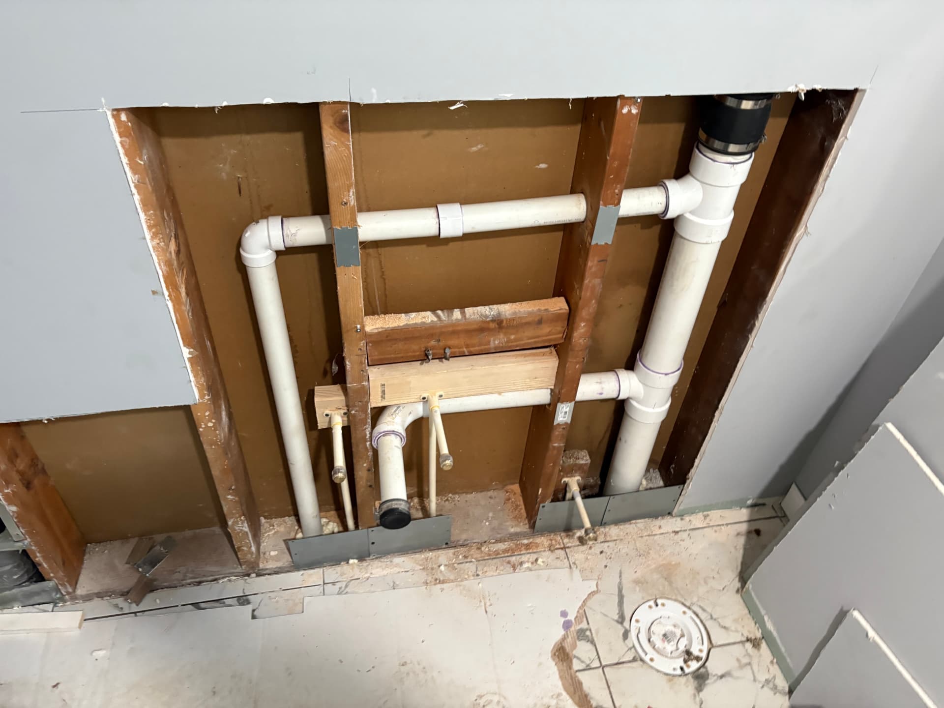 Bathroom wall rough-in with PVC vent and drain lines for a sink and toilet in Baltimore, MD — ProStream Plumbing