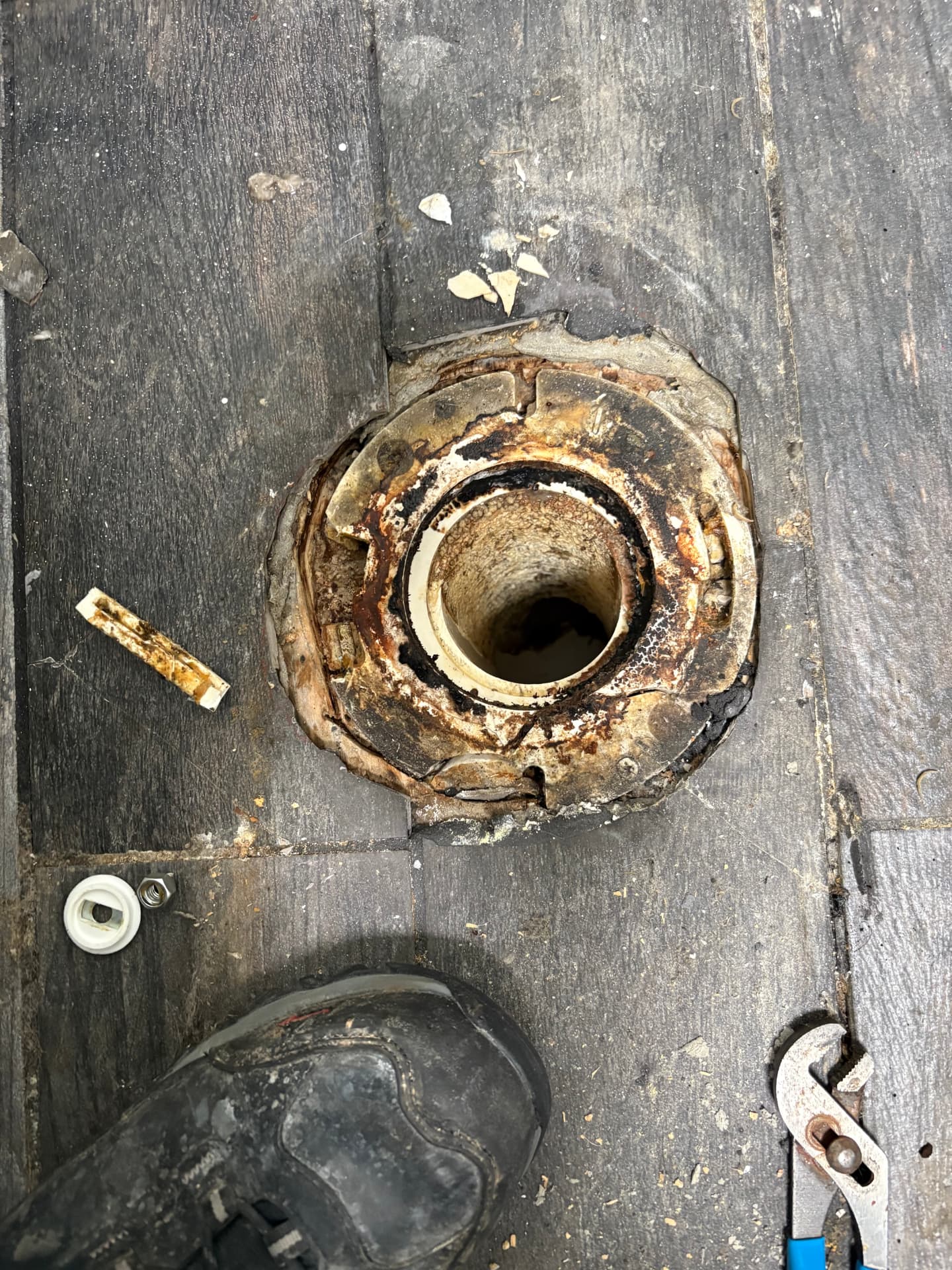 Rusted leaking toilet flange before replacement in Baltimore, MD — ProStream Plumbing