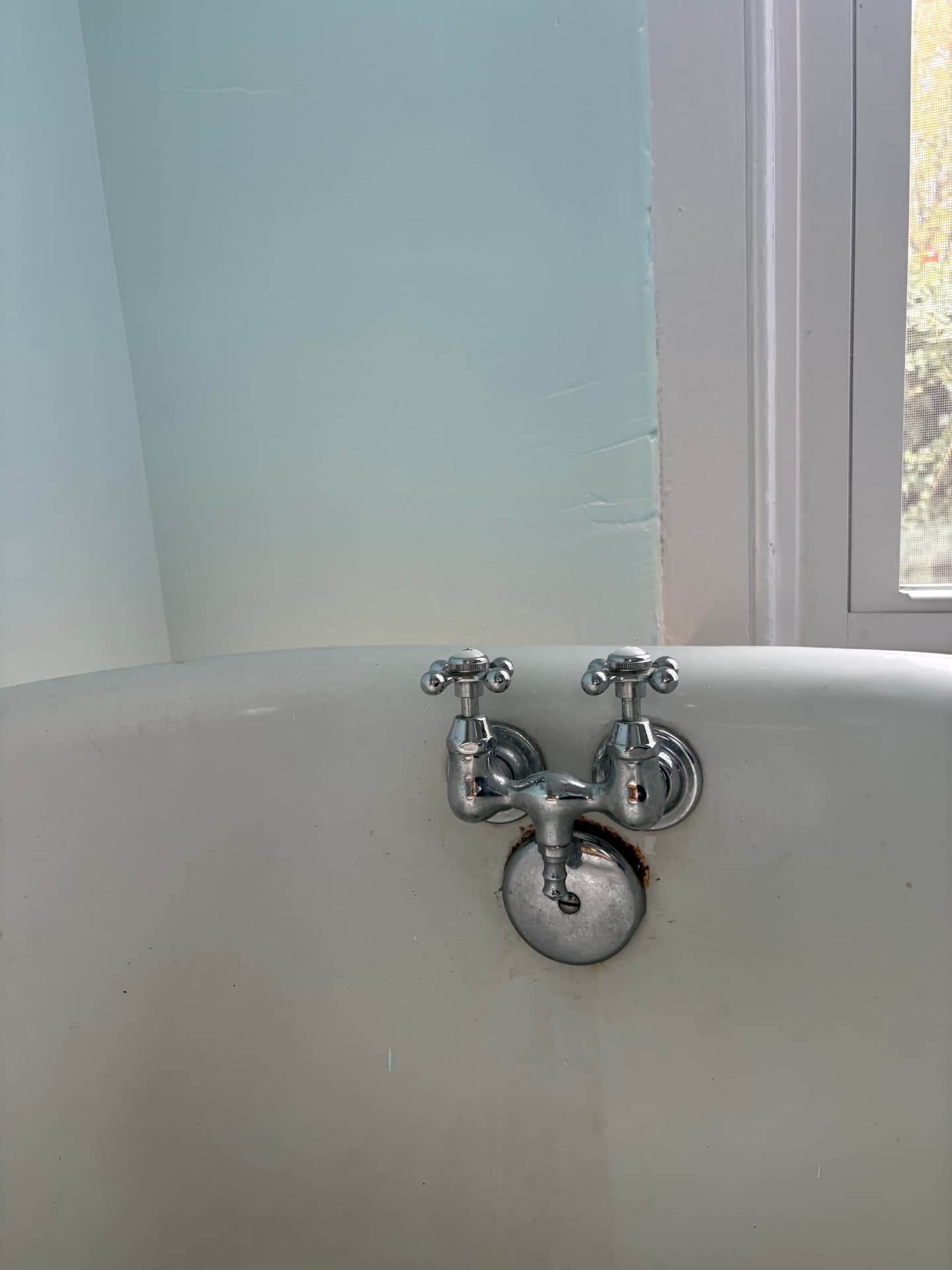 Old rusted chrome clawfoot tub faucet before replacement in Baltimore, MD — ProStream Plumbing
