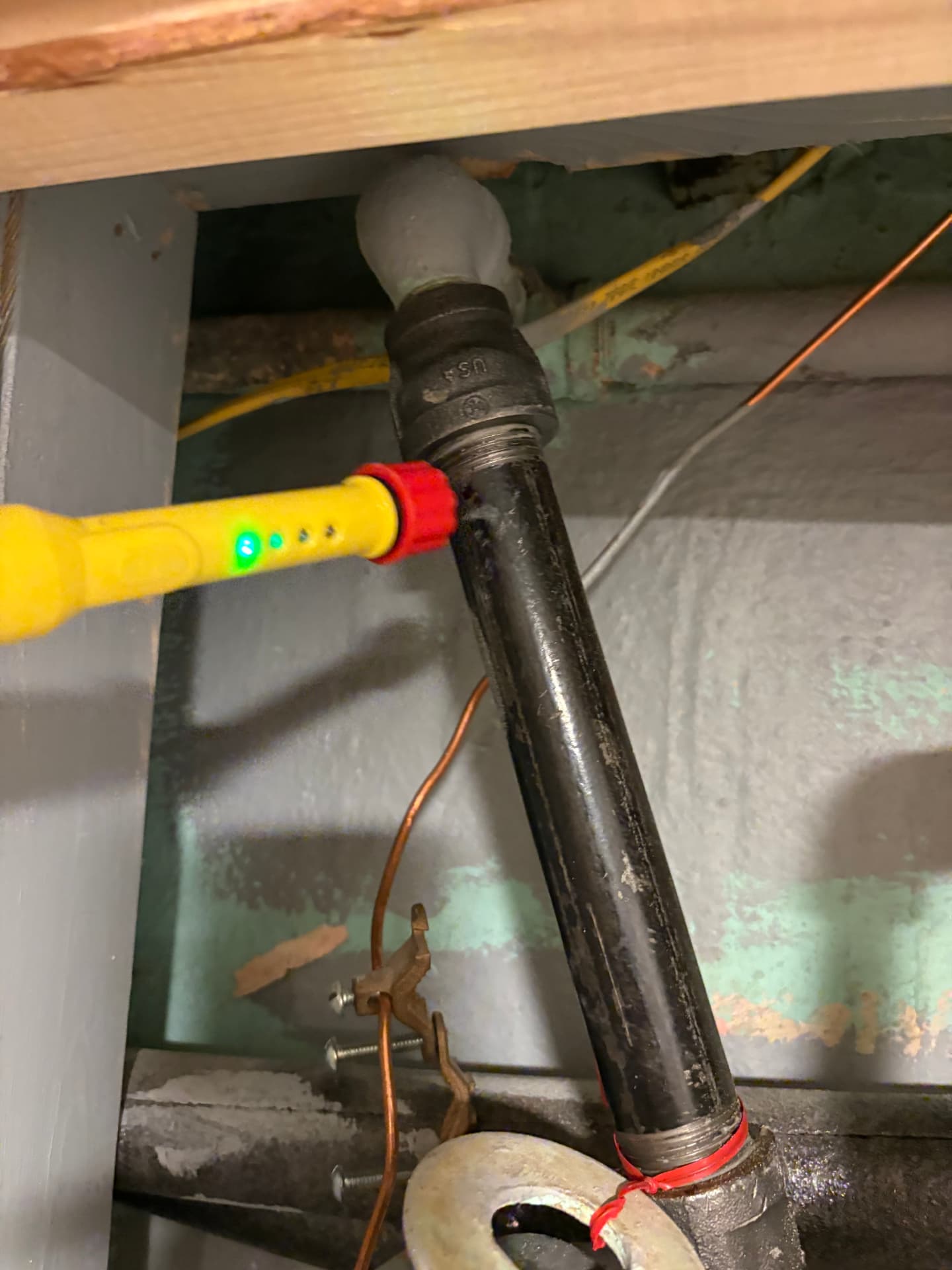 Gas leak detector being used to test a black iron gas pipe in a basement in Baltimore, MD — ProStream Plumbing