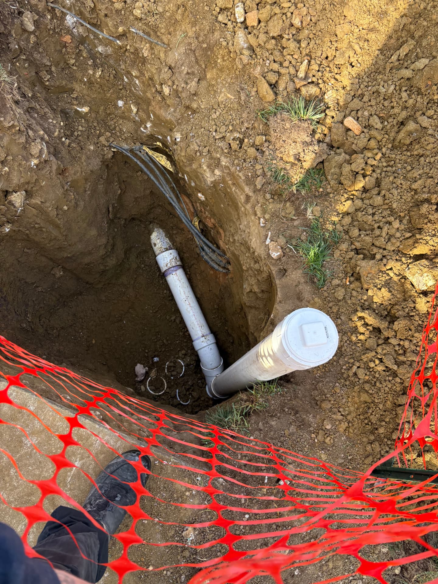 Exterior sewer excavation with new PVC junction and cleanout riser in Baltimore, MD — ProStream Plumbing