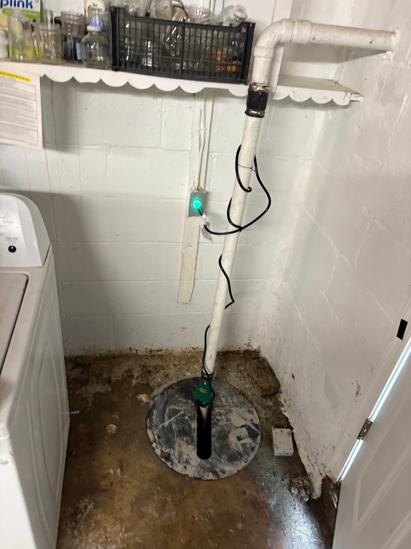 Sump pump discharge pipe with check valve in a basement in Baltimore, MD — ProStream Plumbing