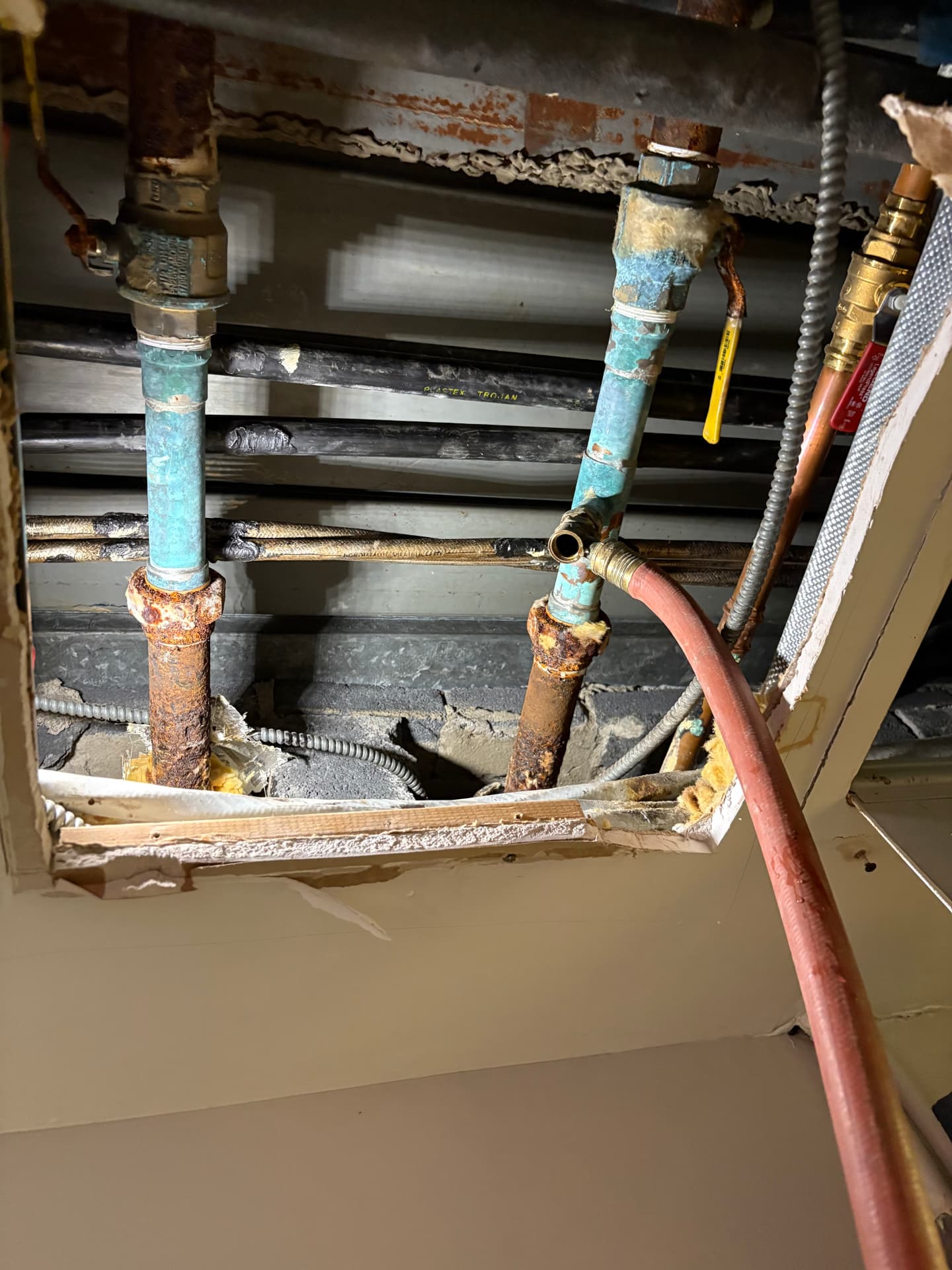 Corroded galvanized iron water pipes in a ceiling before replacement in Baltimore, MD — ProStream Plumbing