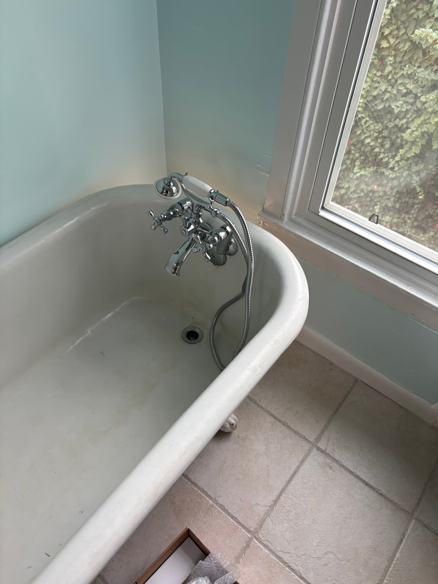 Installed clawfoot tub filler viewed with the tiled bathroom floor in Baltimore, MD — ProStream Plumbing