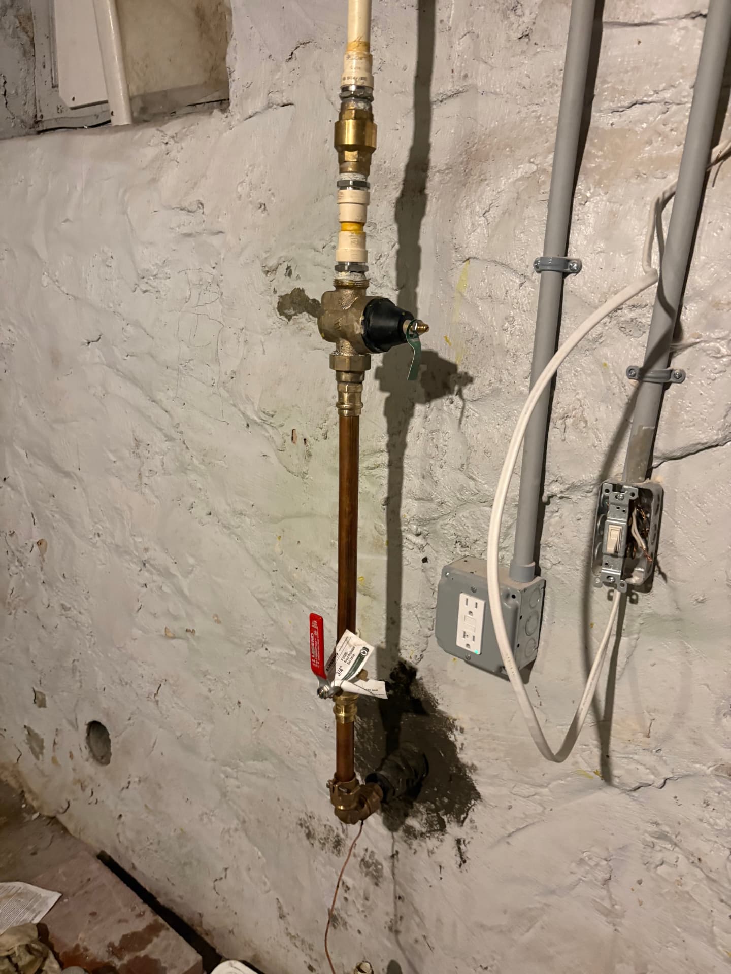 Copper water service line with brass PRV and ball valve on a masonry wall in Glen Burnie, MD — ProStream Plumbing