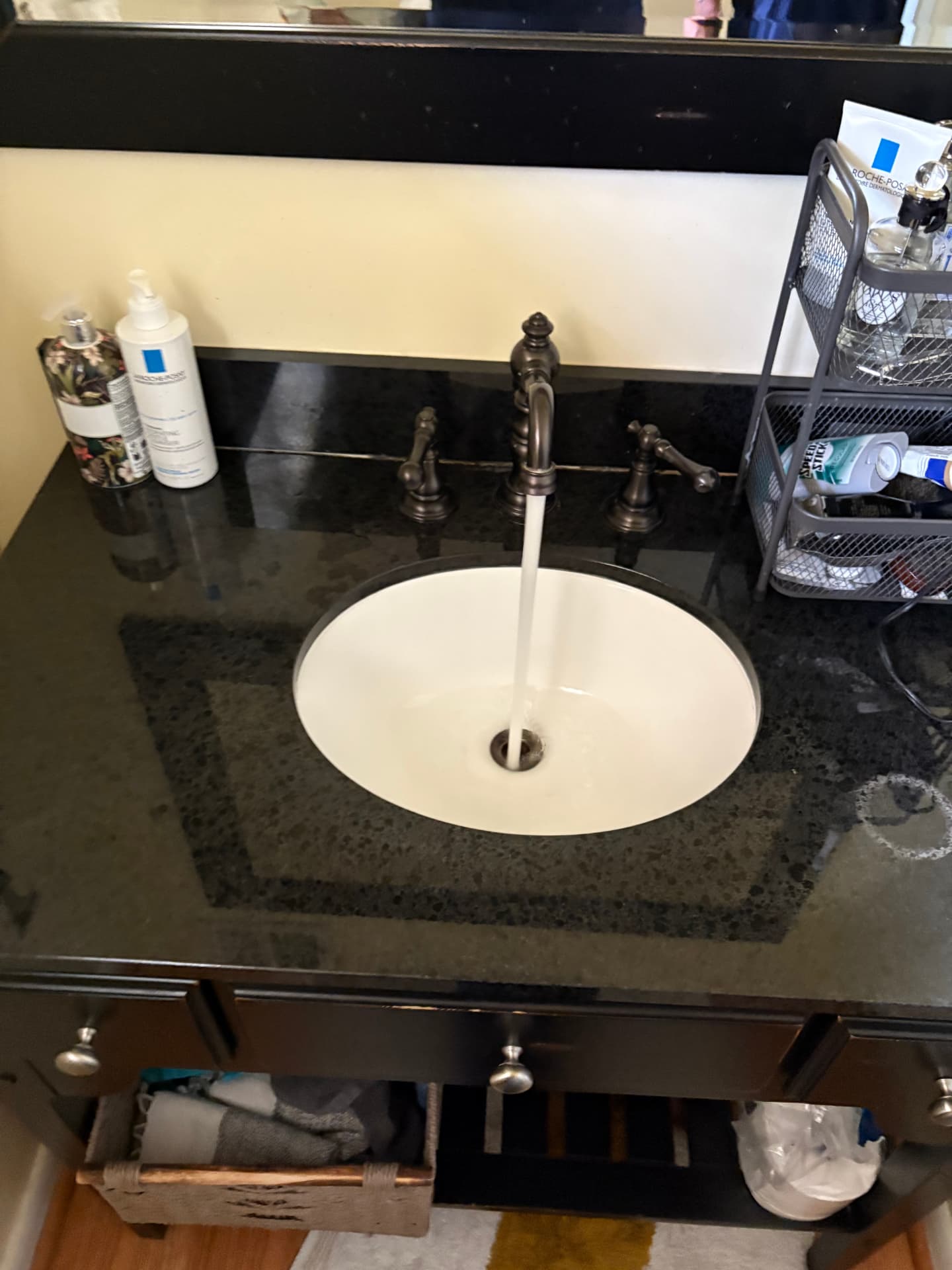 New oil-rubbed bronze bathroom faucet running into an oval sink in Baltimore, MD — ProStream Plumbing