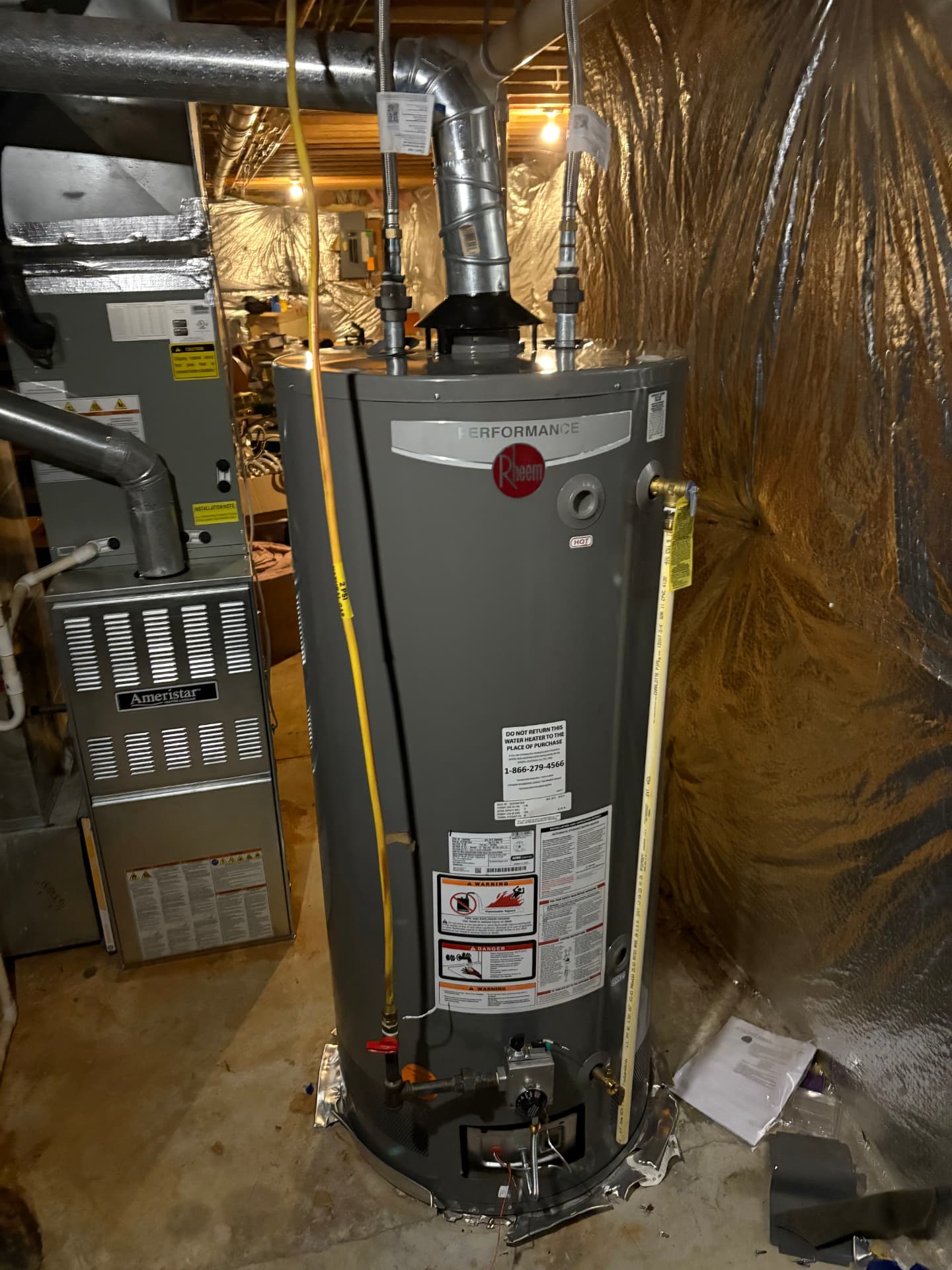 New Rheem gas water heater installed beside a furnace in Baltimore, MD — ProStream Plumbing