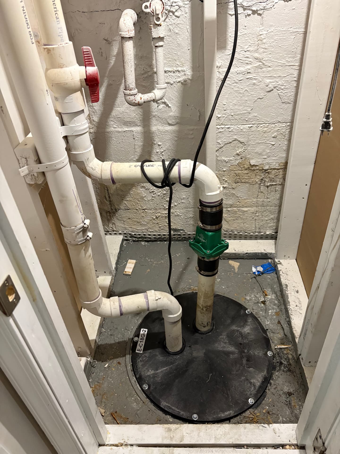 Sealed sump basin with new pump and PVC discharge piping in Baltimore, MD — ProStream Plumbing