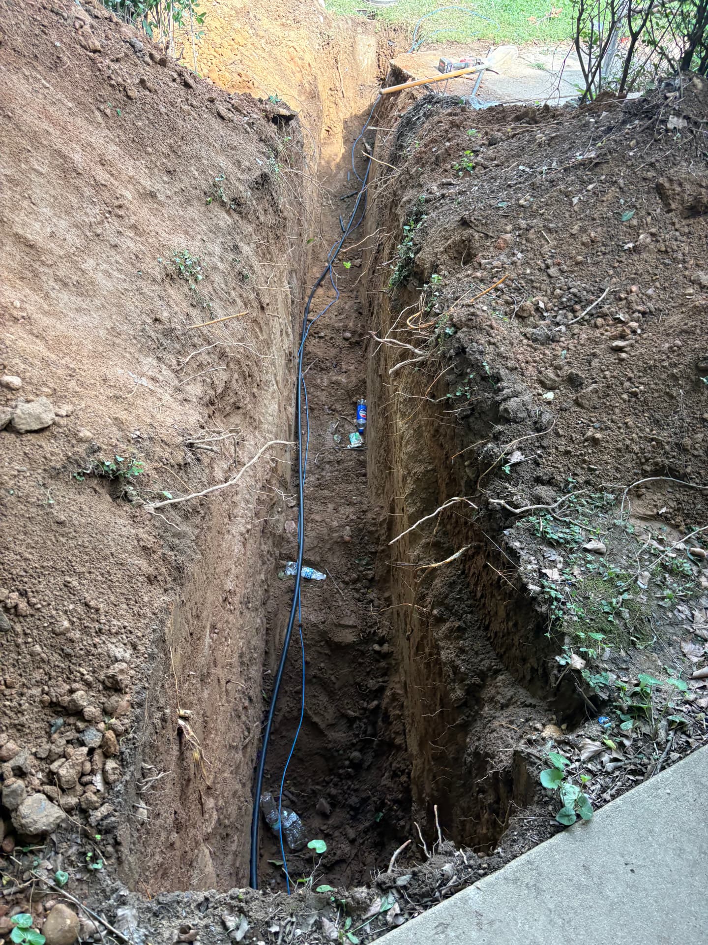 Open sewer line trench showing the buried service line at depth in Baltimore, MD — ProStream Plumbing