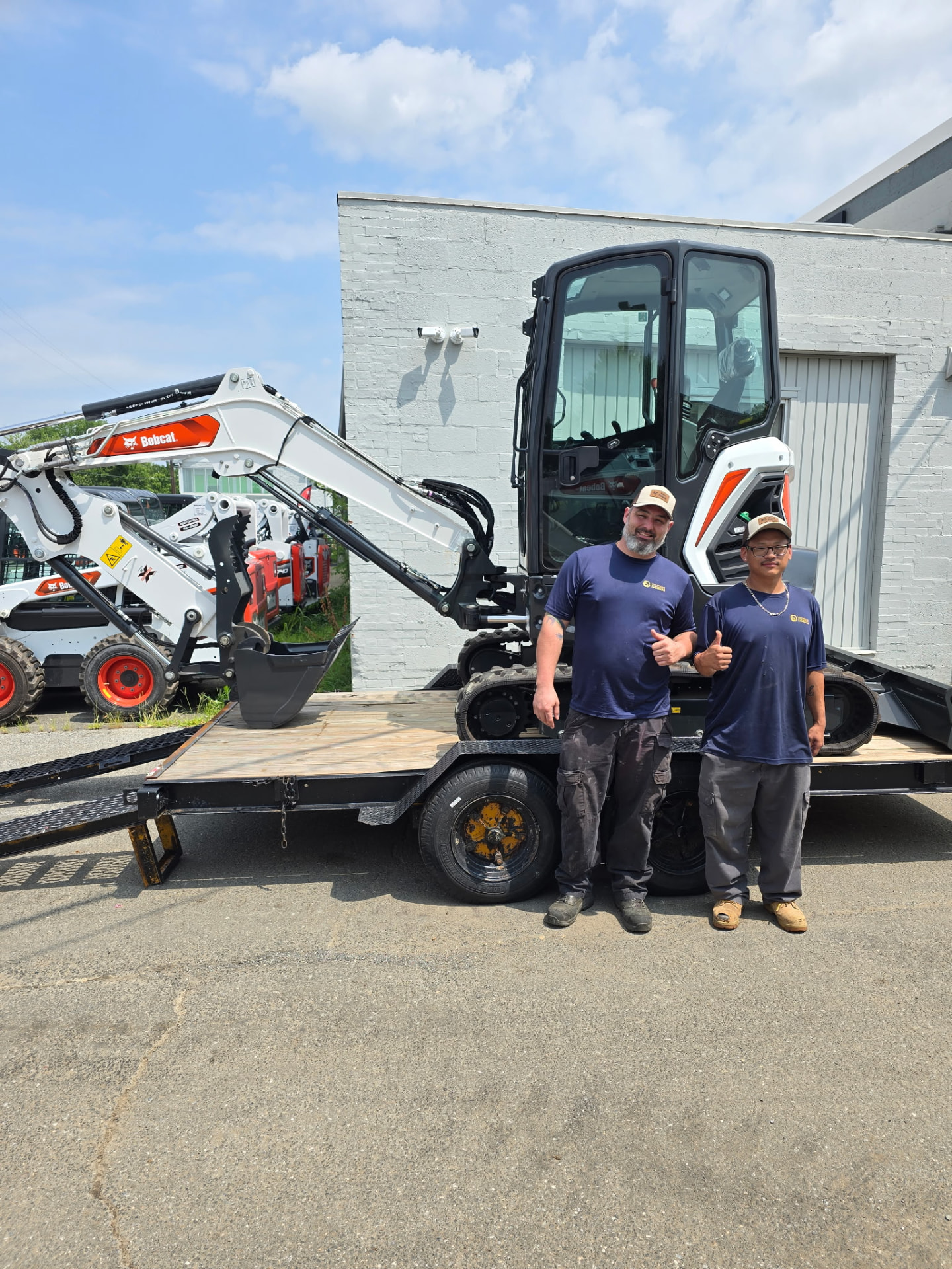 Owner Daniel and a ProStream technician with the mini excavator used for sewer and water main digs in Baltimore, MD — ProStream Plumbing