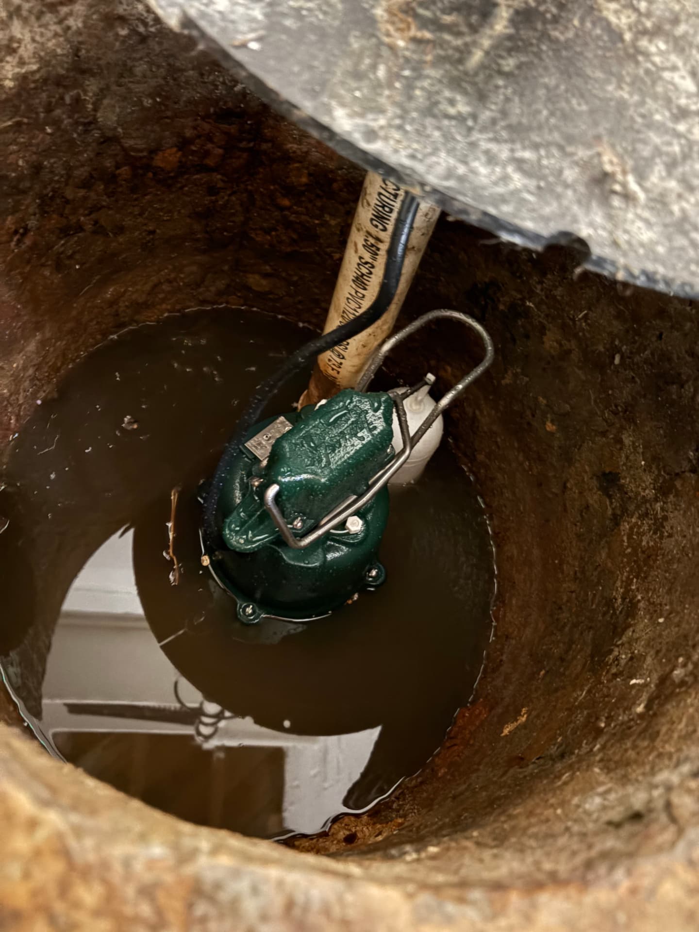 Submersible sump pump seated in a water-filled basin in Glen Burnie, MD — ProStream Plumbing